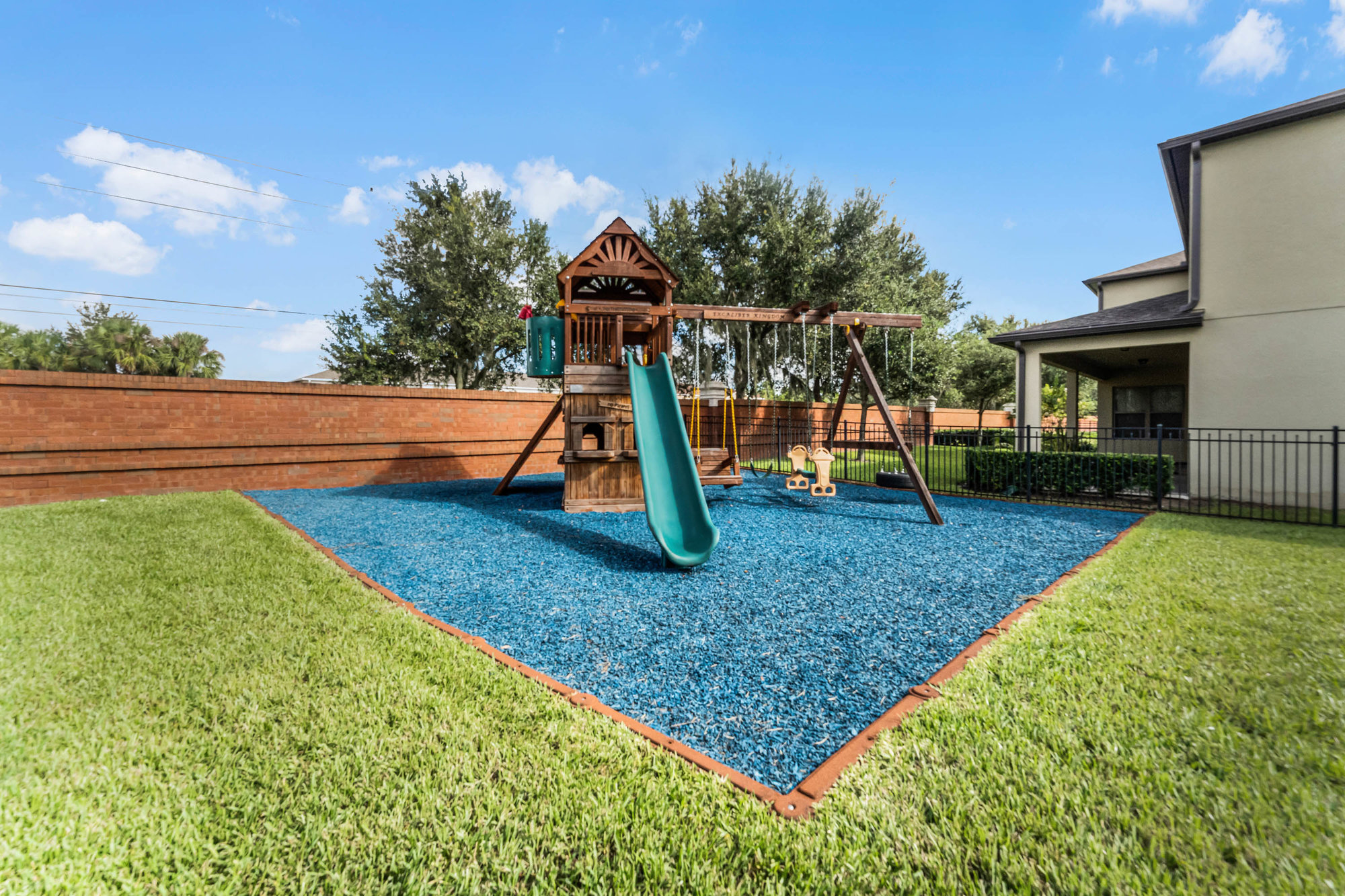 backyard with mulched park and play set